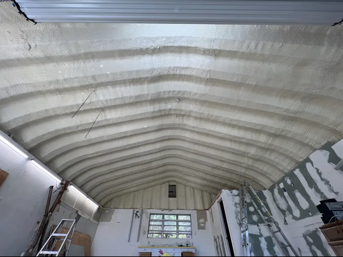 Spray polyurethane foam applied to the underside of a metal roof deck in Temple